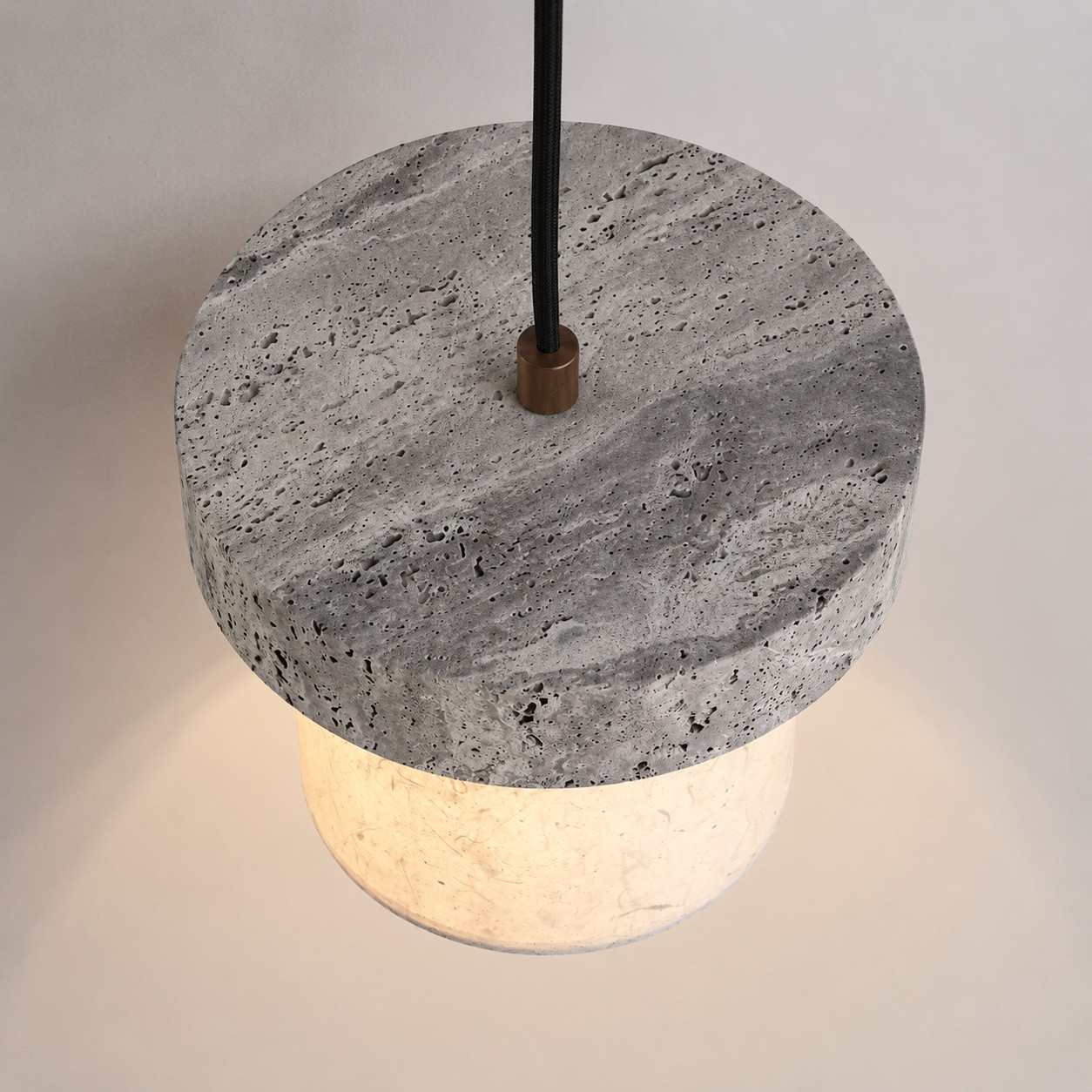 Vue de dessus d'un pendentif en travertin gris avec cordon de connexion