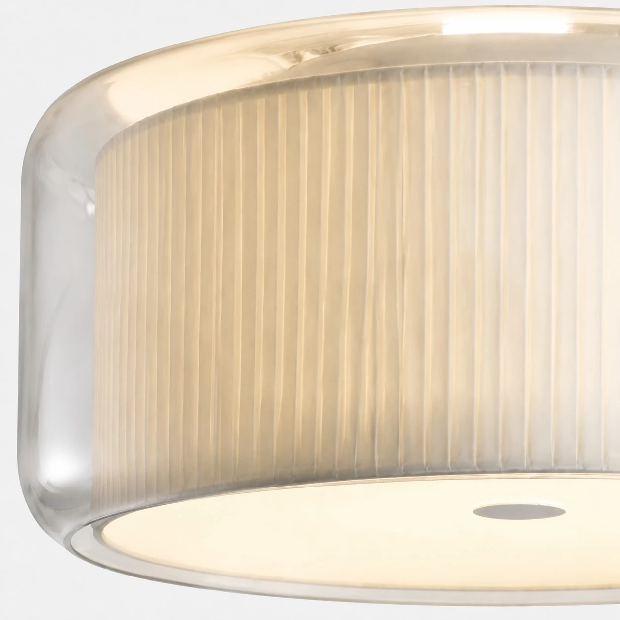 Close view of the pleated fabric shade protected by clear glass