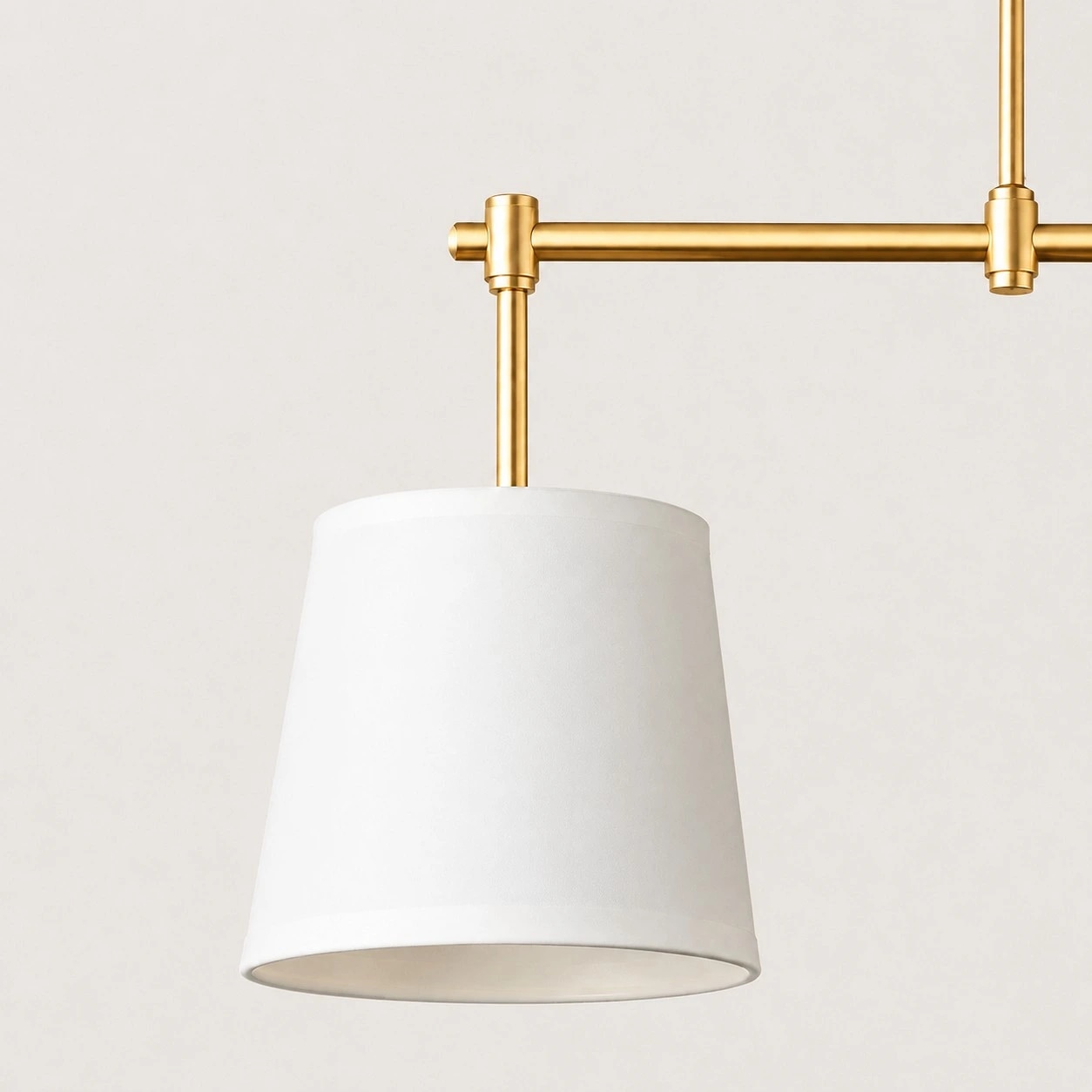 Dumora fabric shade and antique brass arm close view