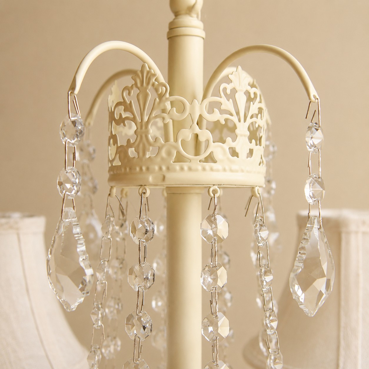 Close view of the decorative iron crown and clear hanging accents