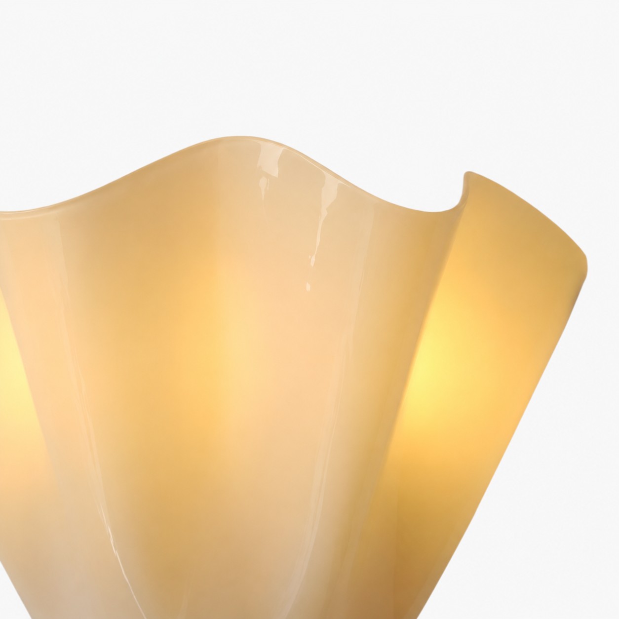 Close-up of cream glass with a waved rim