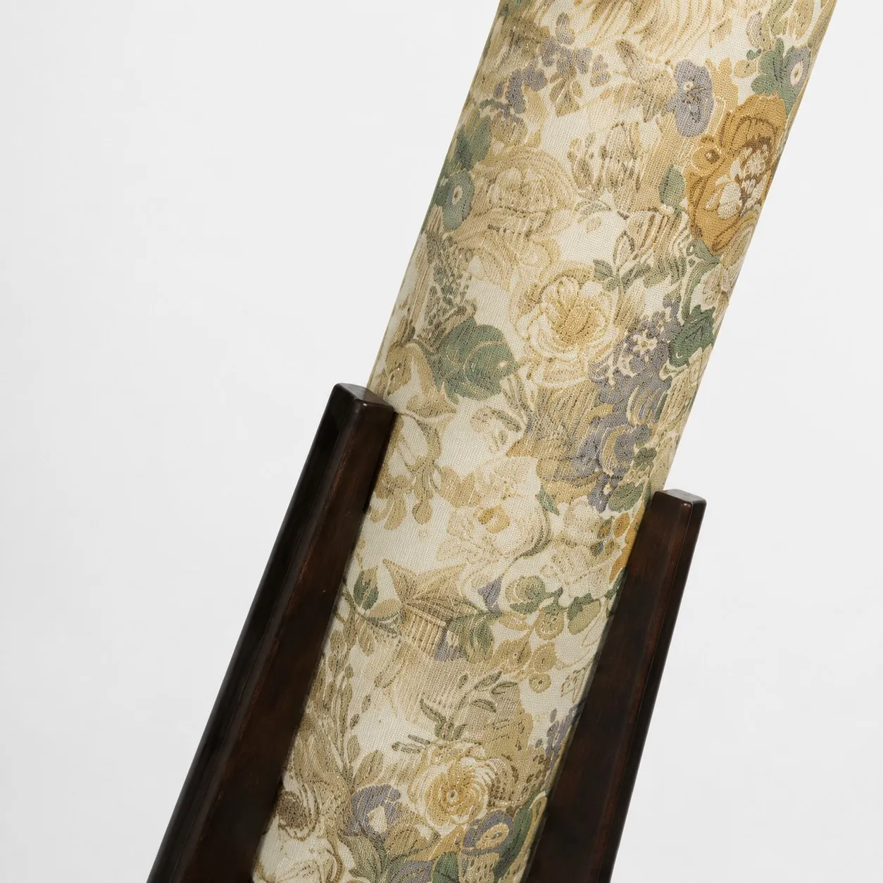 Close-up of Liberty fabric shade supported by dark solid wood tripod legs