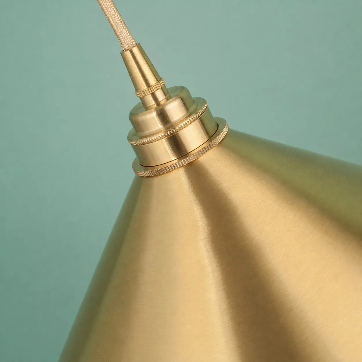 Tapered brass shade surface and upper fitting detail