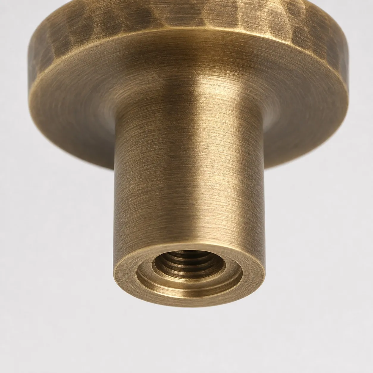Close view of threaded mounting hole on antique brass knob