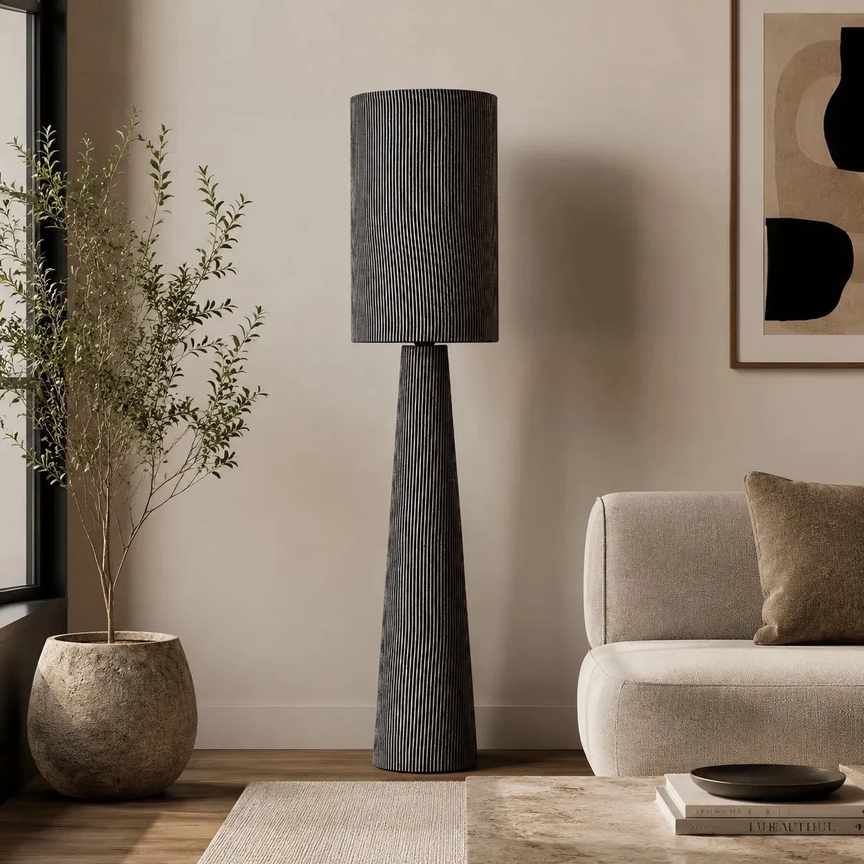 Gray striped floor lamp beside a cream sofa in a living room